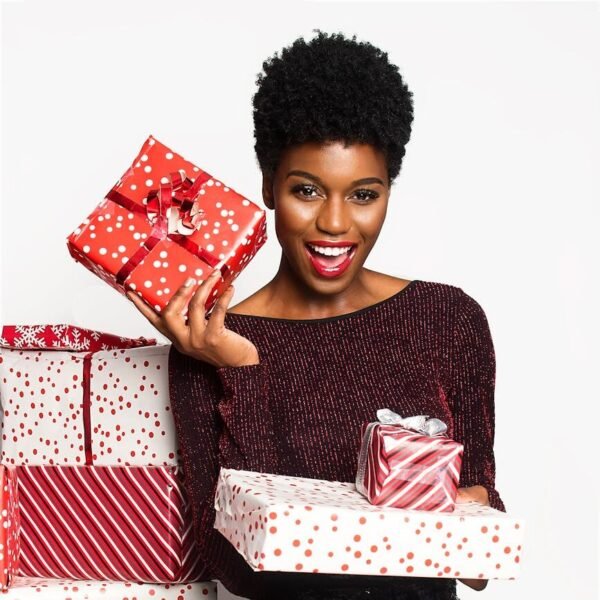 woman wearing maroon long sleeved shirt and black shorts holding gift boxes