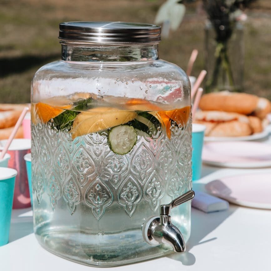 selective focus of a glass drink dispenser containing lemonade drink